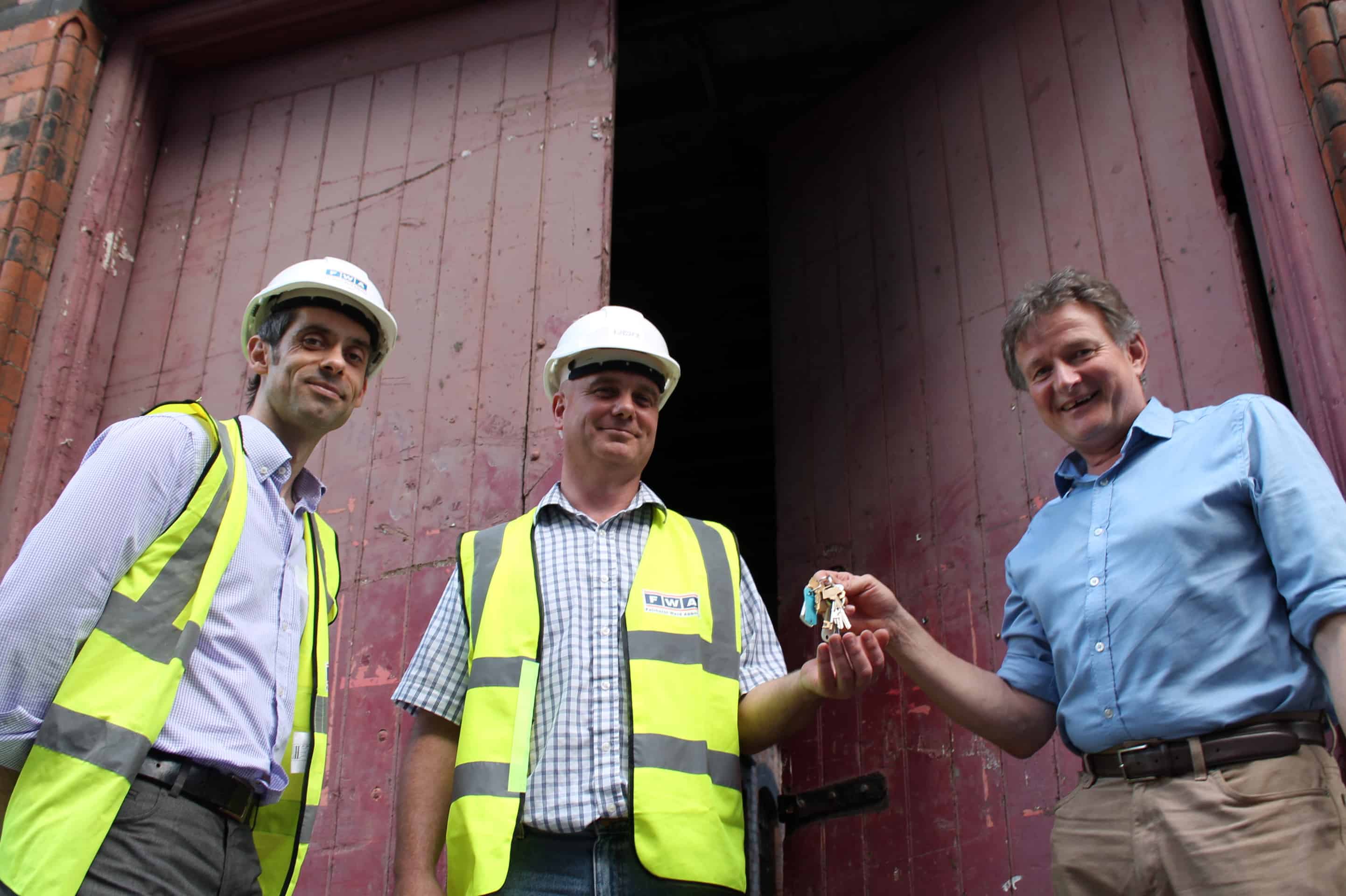 BCT's Simon Buteux (far right), hands over the keys to Andy King and Ian Bird from Fairhurst Ward Abbotts. 
