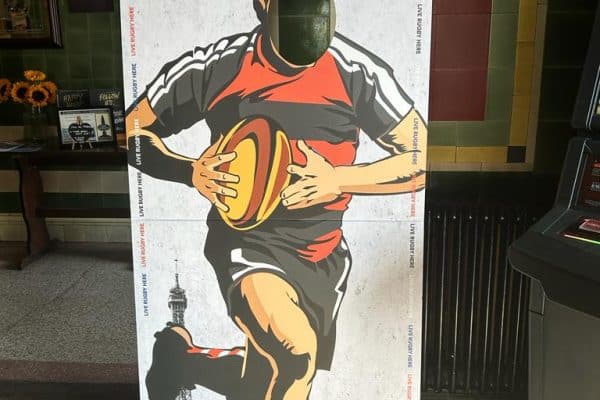 Live size stand of rugby player with face cut out for photo opportunities.